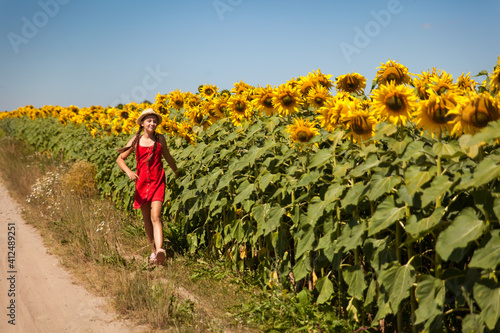 Beautiful young girl in a field of sunflowers
