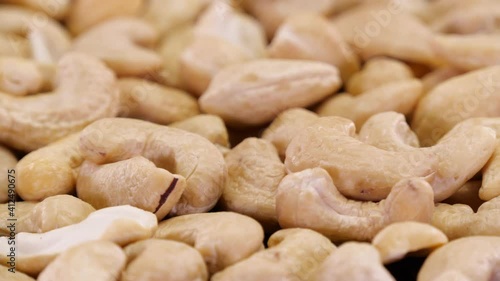 Cashew nuts rotating on close up. Cashew, organic ecological nuts isolated. photo