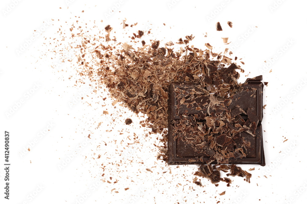 Chocolate pieces and grated flakes, shavings pile isolated on white background, top view