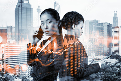 Photography Two young astonishing businesswoman in suits working on forecasting trading corporate strategy at fund