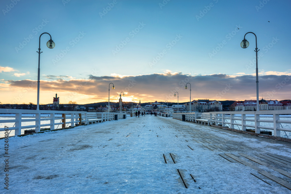 Beautiful sunset over the snowy pier (Molo) in Sopot at winter. Poland