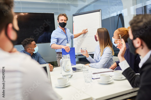 Business man with mask at a presentation