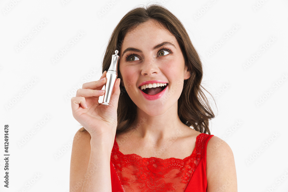 Happy beautiful caucasian girl smiling while posing with perfume Happy beautiful caucasian girl smiling while posing with perfume
