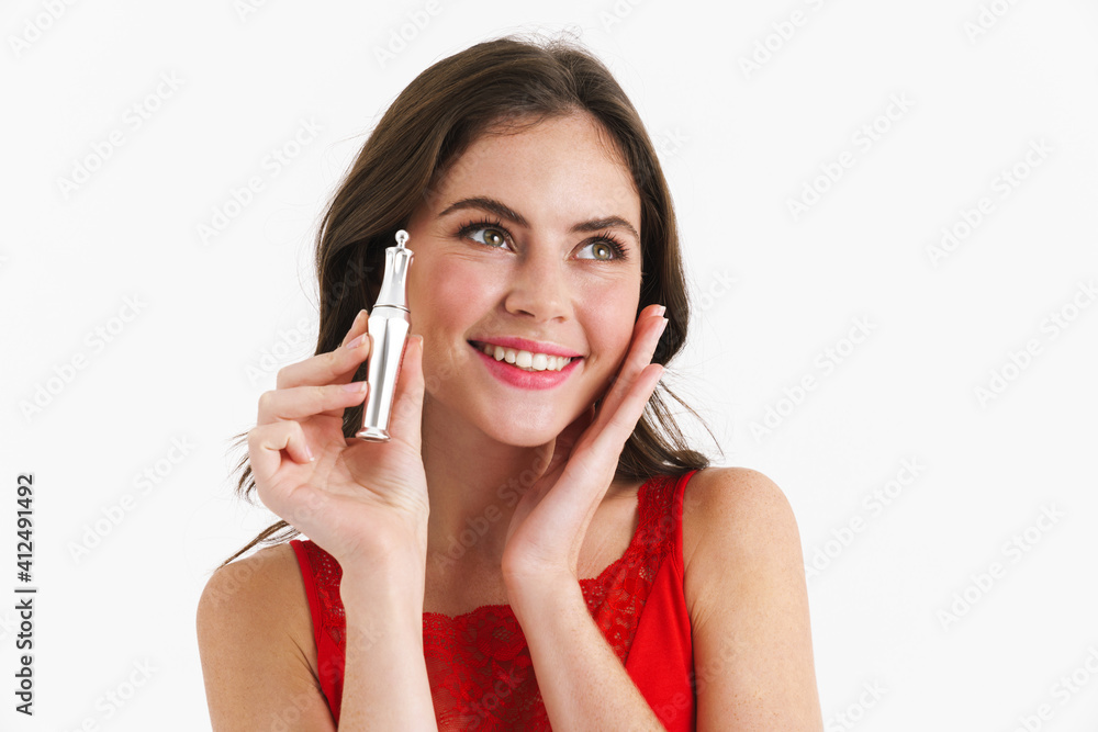 Happy beautiful caucasian girl smiling while posing with perfume Happy beautiful caucasian girl smiling while posing with perfume