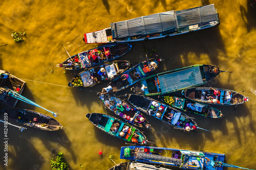 Can Tho Jan 21, 2020. Aerial view of Cai Rang floating market at sunrise, boats selling wholesale fruits and goods on Can Tho River, Mekong Delta region, South Vietnam, tourism destination
 photo