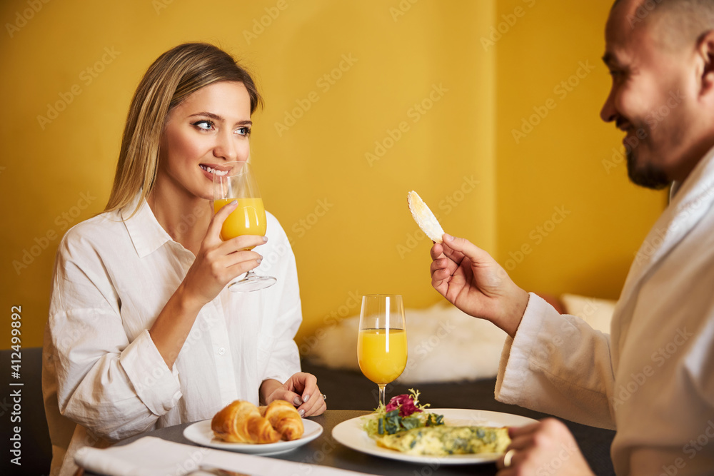 Loving man treating his wife to a crouton Loving man treating his wife to a crouton