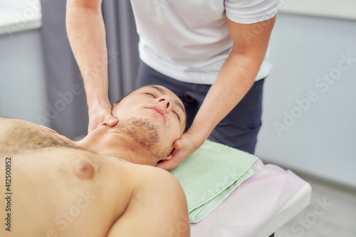 Neck and collar zone massage. The man is being massaged at the spa.