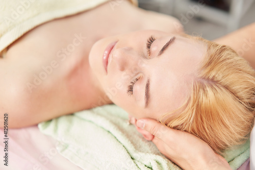 Chiroplastic facial massage. Relaxing procedures for a woman in a spa salon.