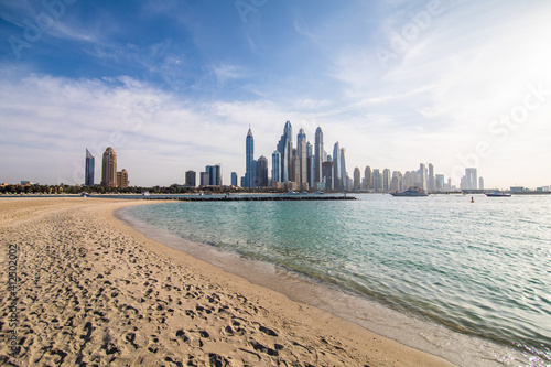 Fototapeta Naklejka Na Ścianę i Meble -  DUBAI, UAE - December, 2020: Skyscrapers and jumeirah beach in Dubai Marina. UAE