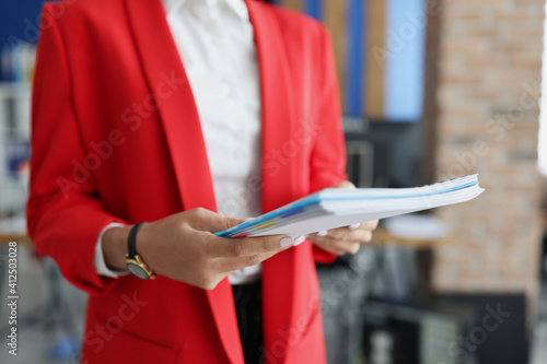 Female hands hold folder with financial documents. Small and medium business development concept