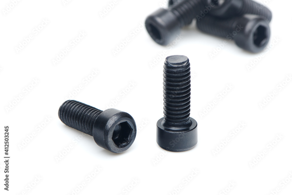 Two black hex screws with hex cap head close up isolated on white background Two black hex screws with hex cap head close up isolated on white background