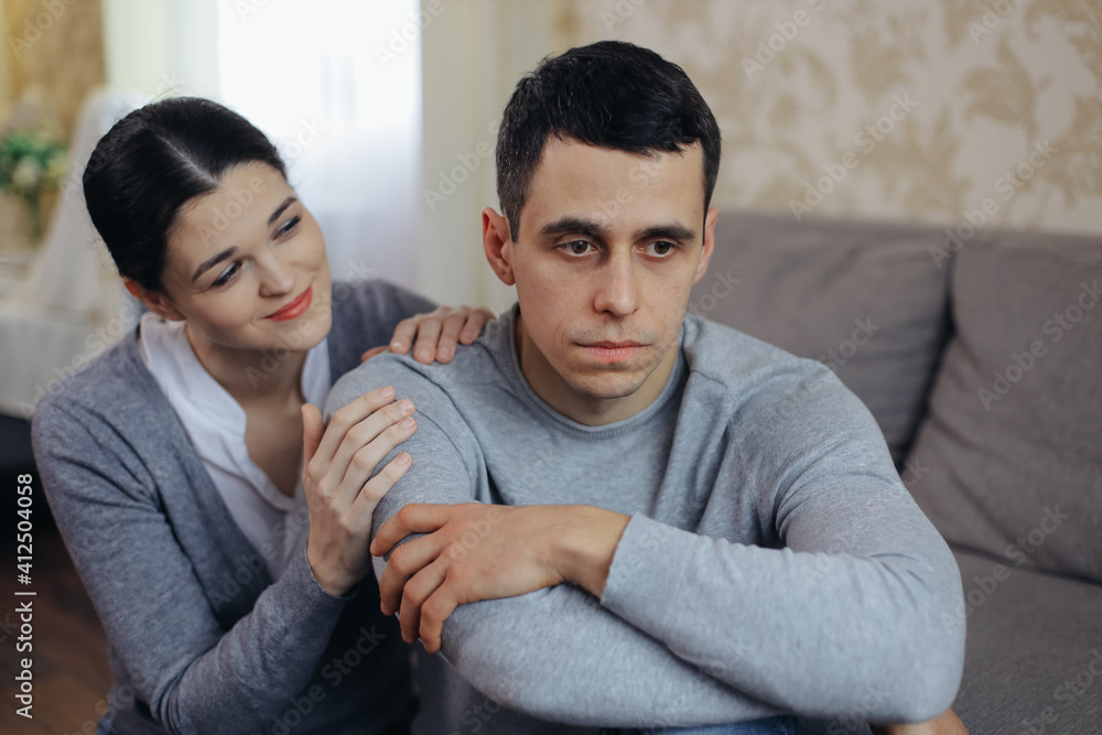 A woman comforts a sad man. Family support A woman comforts a sad man. Family support