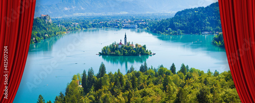Open theater red curtains against Bled lake, the most famous lake in Slovenia with the island of the church (Europe - Slovenia) - concept image