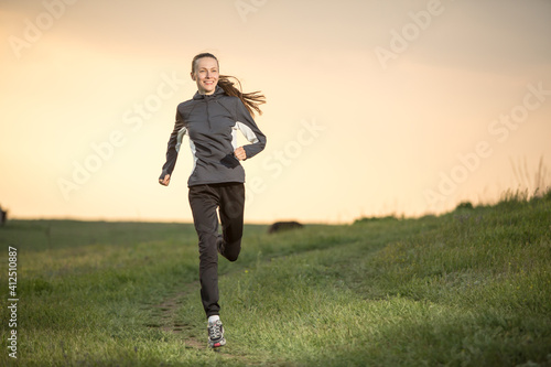 Young woman running through fields