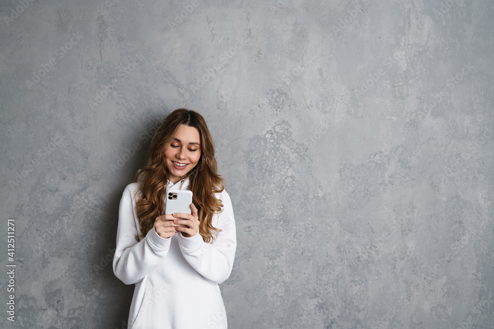 Happy young girl using smartphone isolated Happy young girl using smartphone isolated