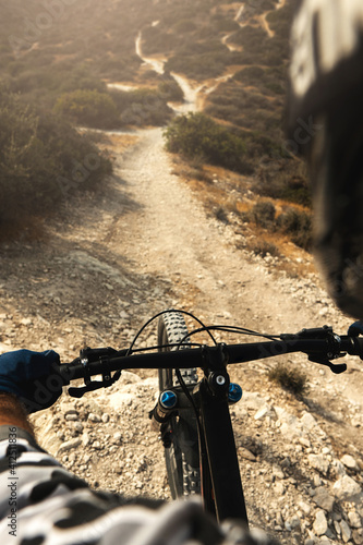 Konstfotografi MTB bike rider during downhill ride on his bicycle in mountains