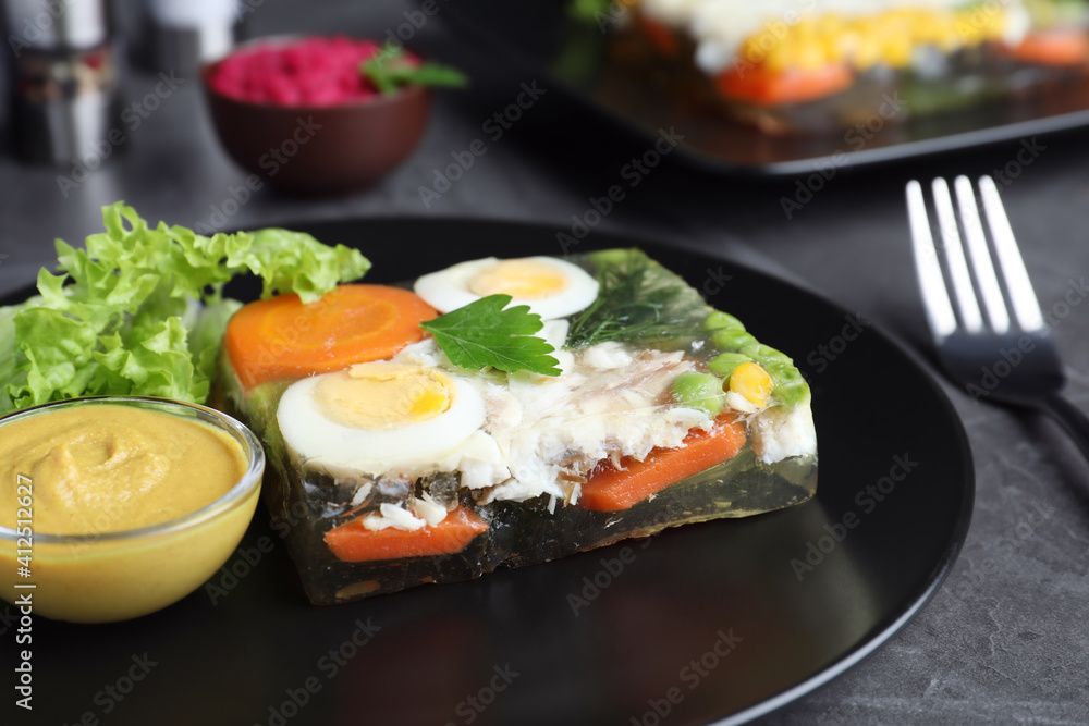 Delicious fish aspic served on black table, closeup Delicious fish aspic served on black table, closeup