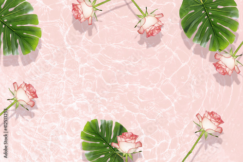 Flat composition of rose flowers and palm leaves on the water surface.
