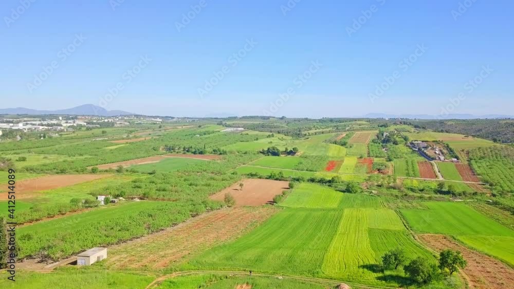 A push out shot of the beautiful countryside under the blue sky in Paralia, Greece. A push out shot of the beautiful countryside under the blue sky in Paralia, Greece.