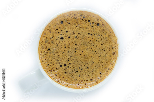 white cup with espresso coffee on a white background view from above