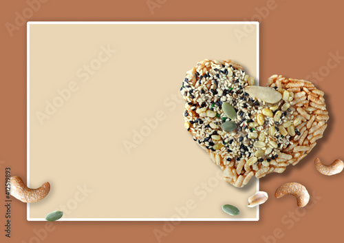 Rice Cracker with Natural Seed in Heart Shape on Background photo