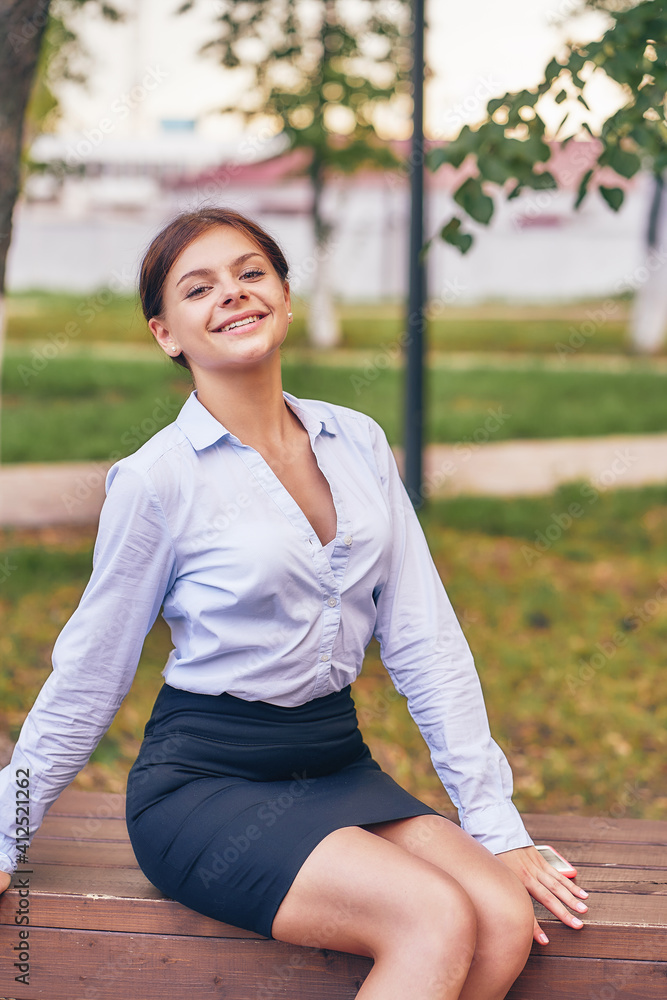 female manager resting in the park. vertical female manager resting in the park. vertical