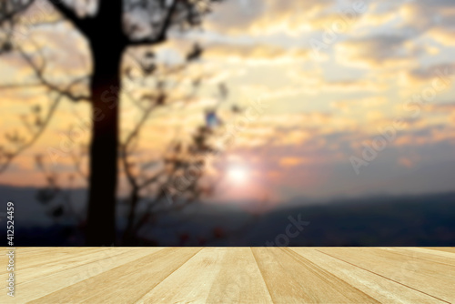 Empty top wooden table on blurred view of beautiful sunset in nature