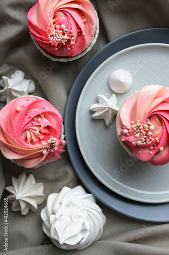 Pink cupcakes with jam, perfect cakes, pink cream cheese on plates