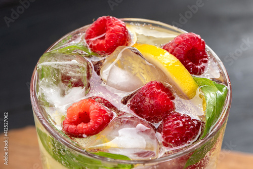 Summer cocktail with raspberry, lemon and mint leaves