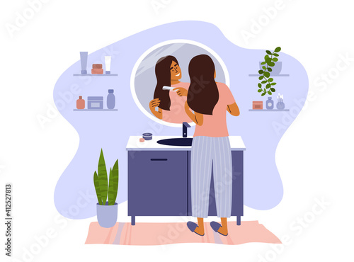 Scene of daily morning or evening routine. Female standing in bathroom combing hair looking at reflection mirror. Young woman making hairstyle by comb. Beauty, self care. Lifestyle vector illustration