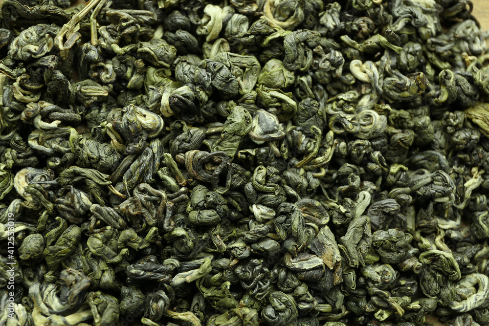 Dry green tea leaves as background, top view Dry green tea leaves as background, top view