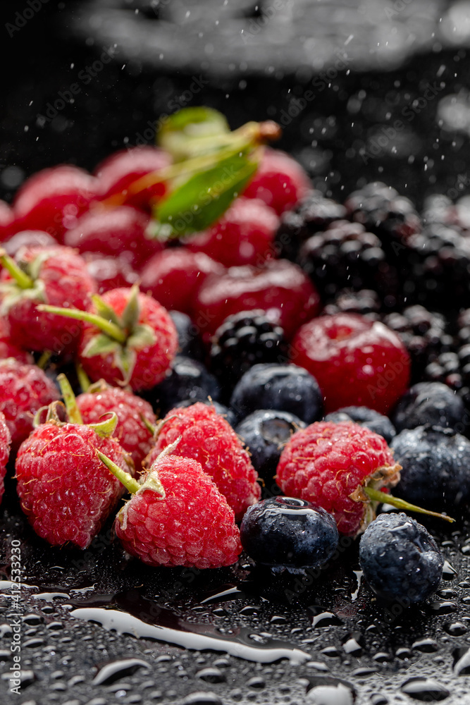 Summer fresh berries and fruits on black background Summer fresh berries and fruits on black background