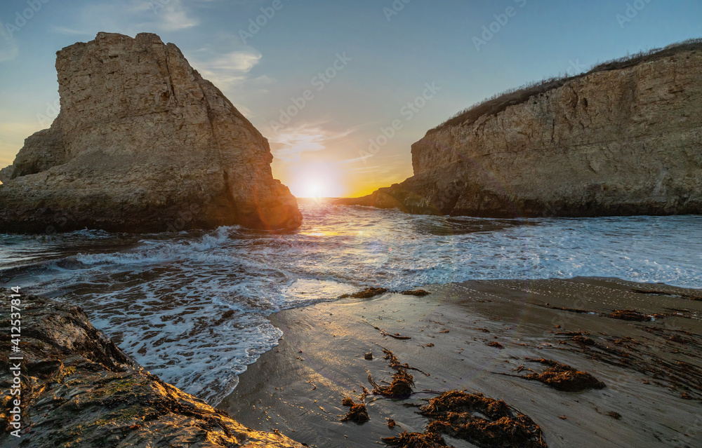 A picturesque sunset in Shark Fin cove, ocean, rocks, beautiful sky. Santa Cruz and Davenport have some of the most beautiful beaches in California.