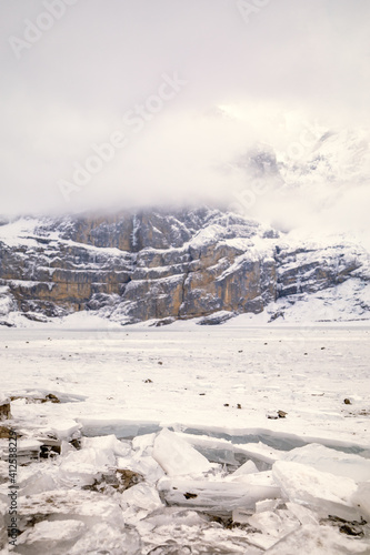 Ice from a frozen lake in a snowy mountain landscape