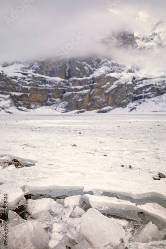 Wallpaper Mural Ice from the edge of a frozen lake in a snowy mountain landscape Torontodigital.ca