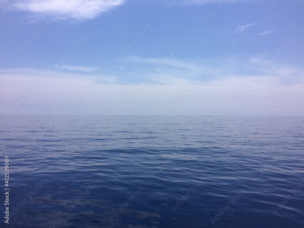Fonde de mar azul y cielo azul con nubes blancas, mar mediterráneo