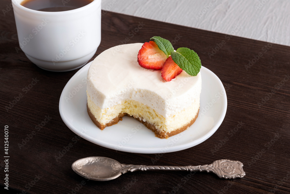 Airy cheese dessert, teaspoon and cup of coffee. Airy cheese dessert, teaspoon and cup of coffee.