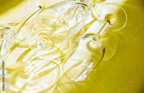 Empty glasses stand on a yellow background, top view.
