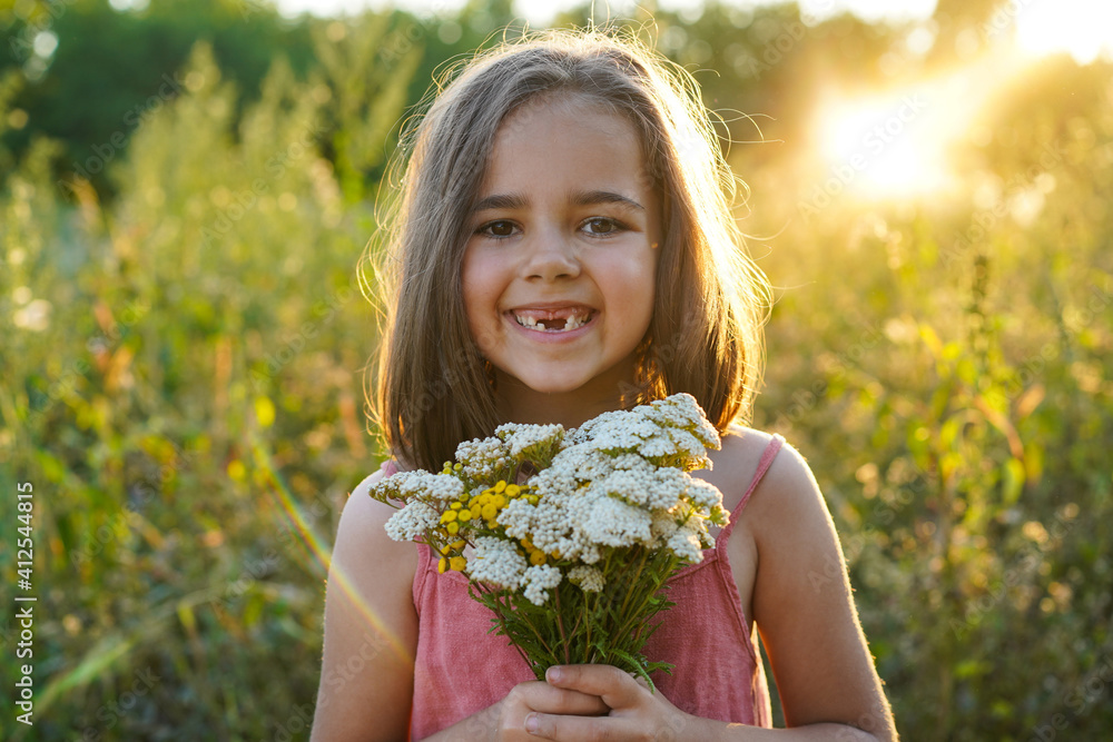 Portrait of a little girl with flowers in the field Portrait of a little girl with flowers in the field