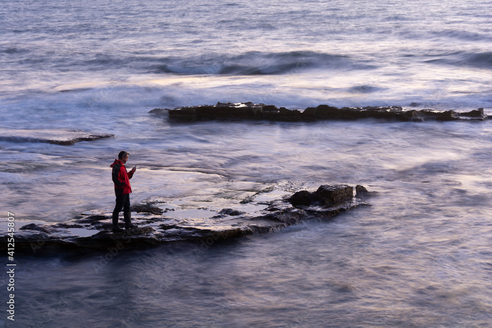 Lonely man with smartphone by the sea Lonely man with smartphone by the sea