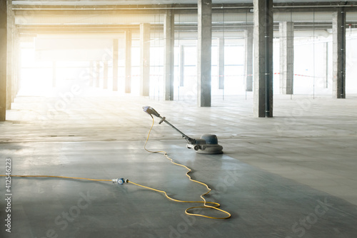 floor polishing machine inside a large industrial building, not people photo