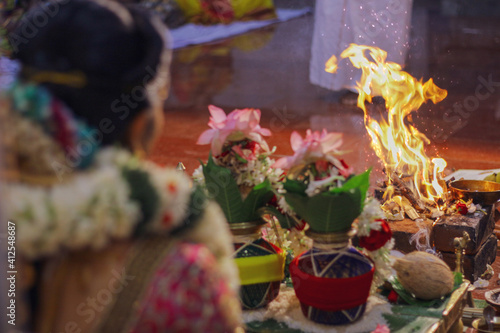 Selective focus shot of a female doing the Yajna/Yagya Hinduism ritual photo