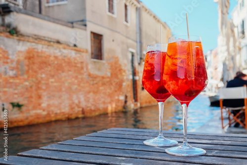 Two glasses of Spritz Veneziano cocktail served near the Venetian canal Fotobehang