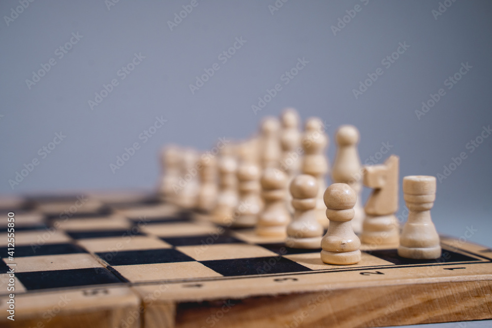 Black and white chess pieces on a chessboard, closeup. Black and white chess pieces on a chessboard, closeup.