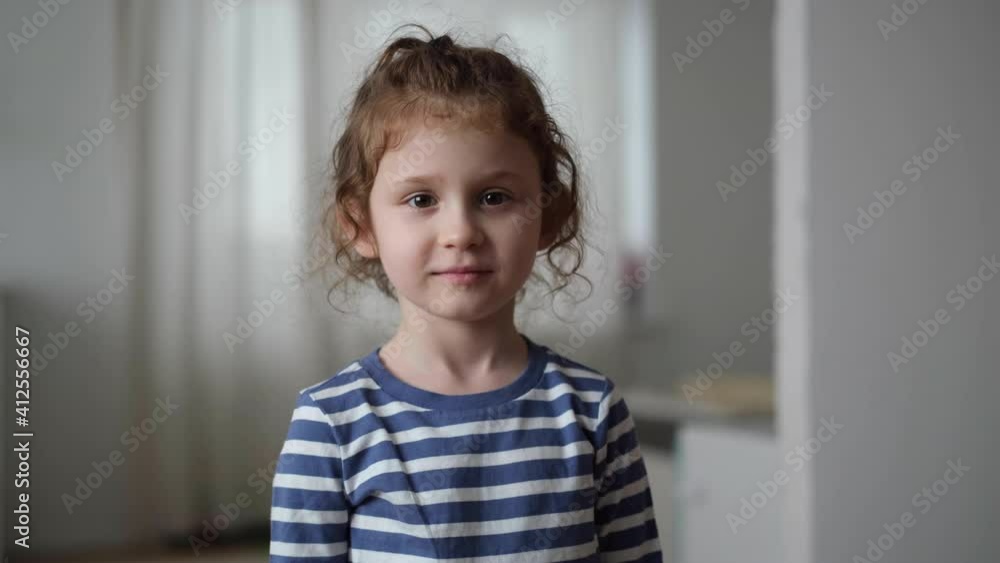 Little cute child girl face portrait looking camera close up home lifestyle Little cute child girl face portrait looking camera close up home lifestyle