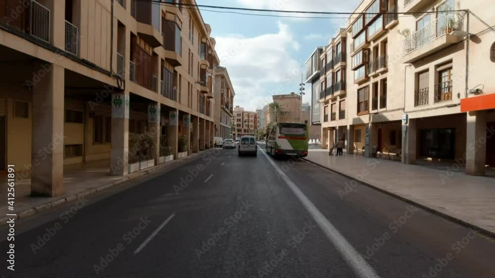 Driving through the Elche downtown, moving car street view. Spain. Famous touristic place concept Driving through the Elche downtown, moving car street view. Spain. Famous touristic place concept
