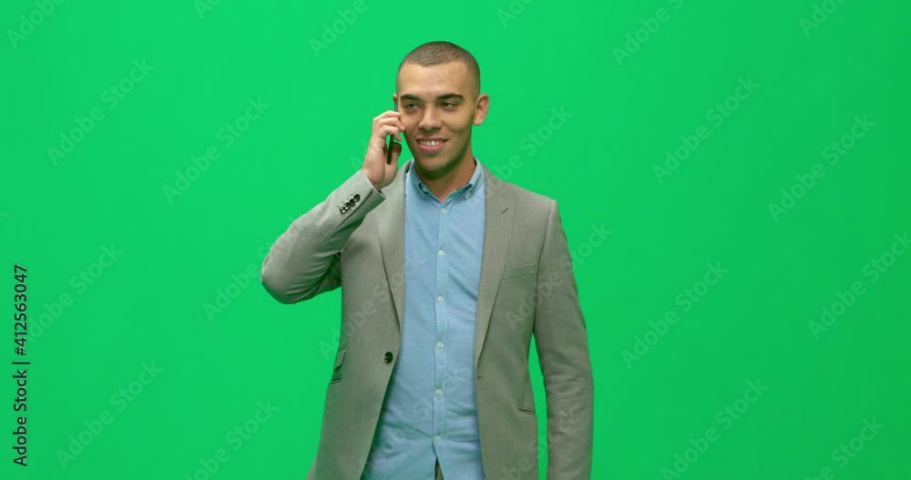 Studio, slow motion, green screen, a young man talks on the phone, London, UK Studio, slow motion, green screen, a young man talks on the phone, London, UK