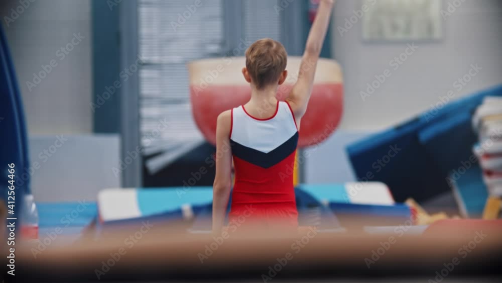 A little gymnastics boy jumping over the barrier A little gymnastics boy jumping over the barrier