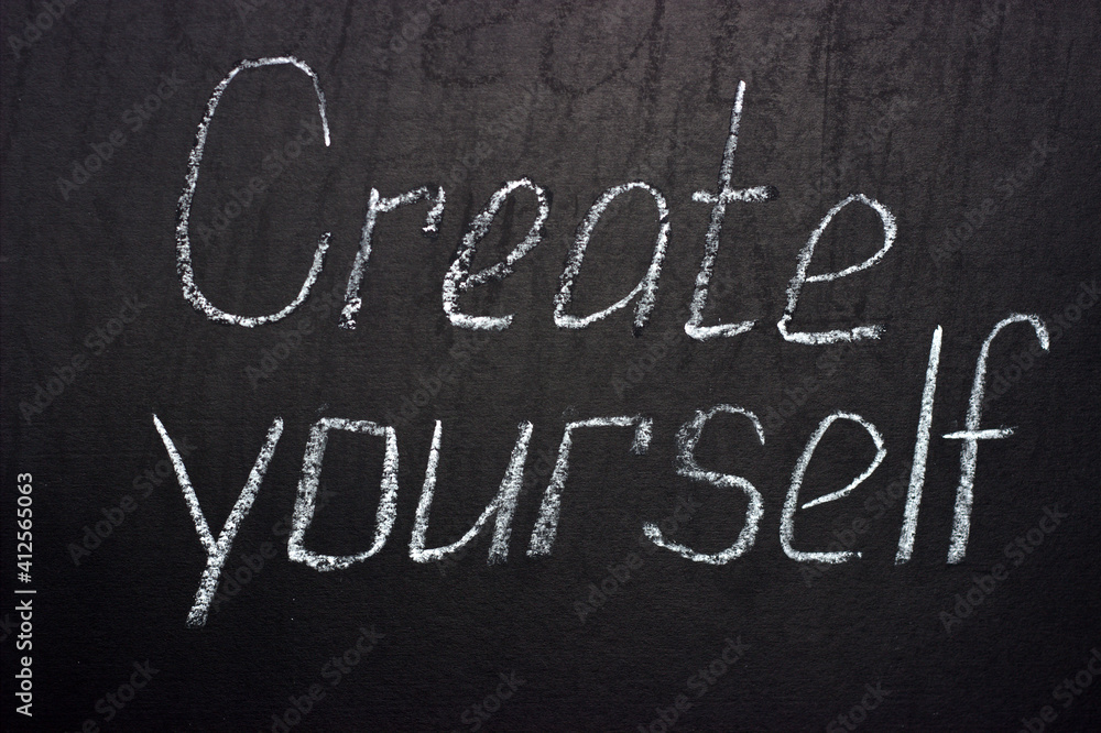 Inscription on a dark board Create yourself. Motivational lettering