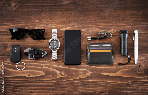 Fotografie, Tablou Flat lay of EDC or Every Day Carry items on wooden background